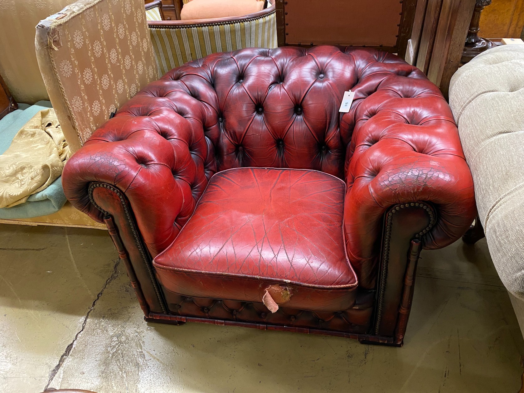 A Victorian style red leather button back Chesterfield armchair, width 104cm, depth 86cm, height 68cm